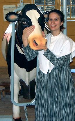 Christina in a Shaker-style dress with a cow